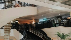 A grand staircase with ornate railings leading to an upper floor.