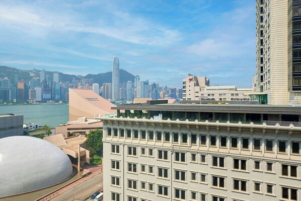 A high-rise building with a modern architectural design, featuring a prominent glass facade and a series of balconies. - Sheraton Hong Kong Hotel & Towers (Kowloon)