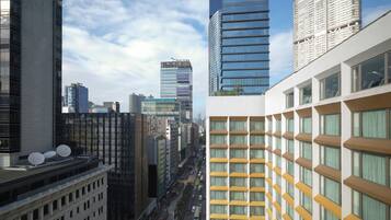 A modern urban skyline with high-rise buildings, a busy street, and a mix of architectural styles.