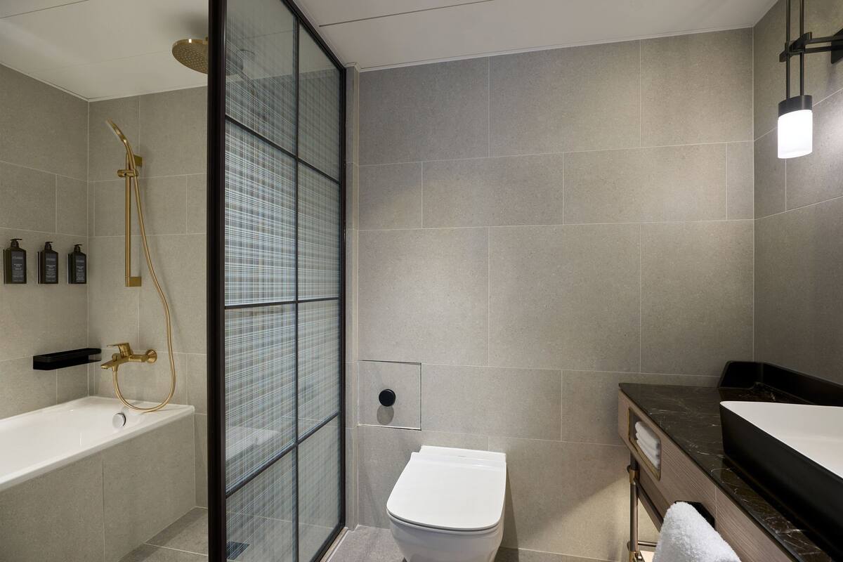 junior suite, 1 bedroom, non smoking | bathroom | combined shower/bathtub, free toiletries, hair dryer, bathrobes