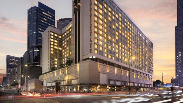A large hotel with multiple floors and a prominent sign.