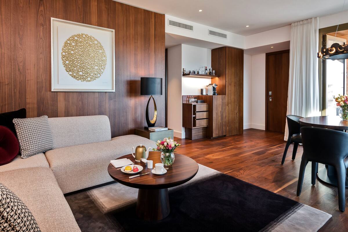 Uma sala de estar moderna com sofá, mesa de centro e área de jantar.