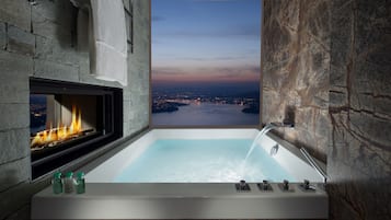 Deep-soaking bathtub, rainfall showerhead, designer toiletries