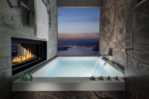 Deep soaking tub, rainfall showerhead, designer toiletries, hair dryer