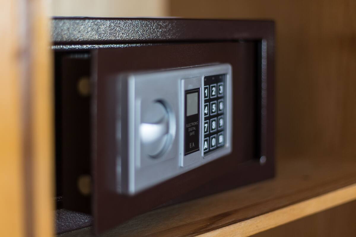 A safe with a keypad and a lock mechanism.