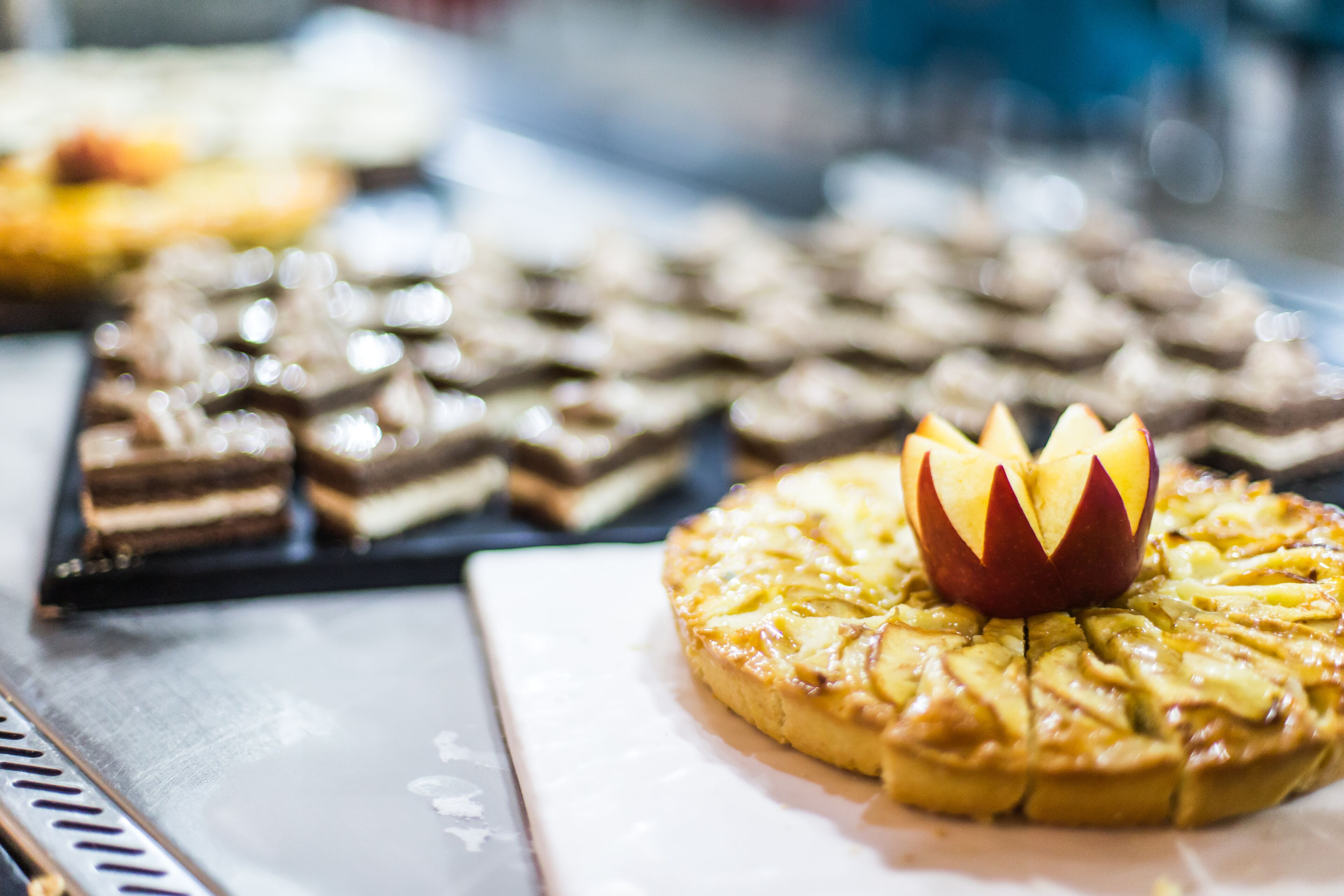 Eine Dessertauslage mit verschiedenen Gebäckstücken und einem auffälligen, apfelartigen Mittelstück.