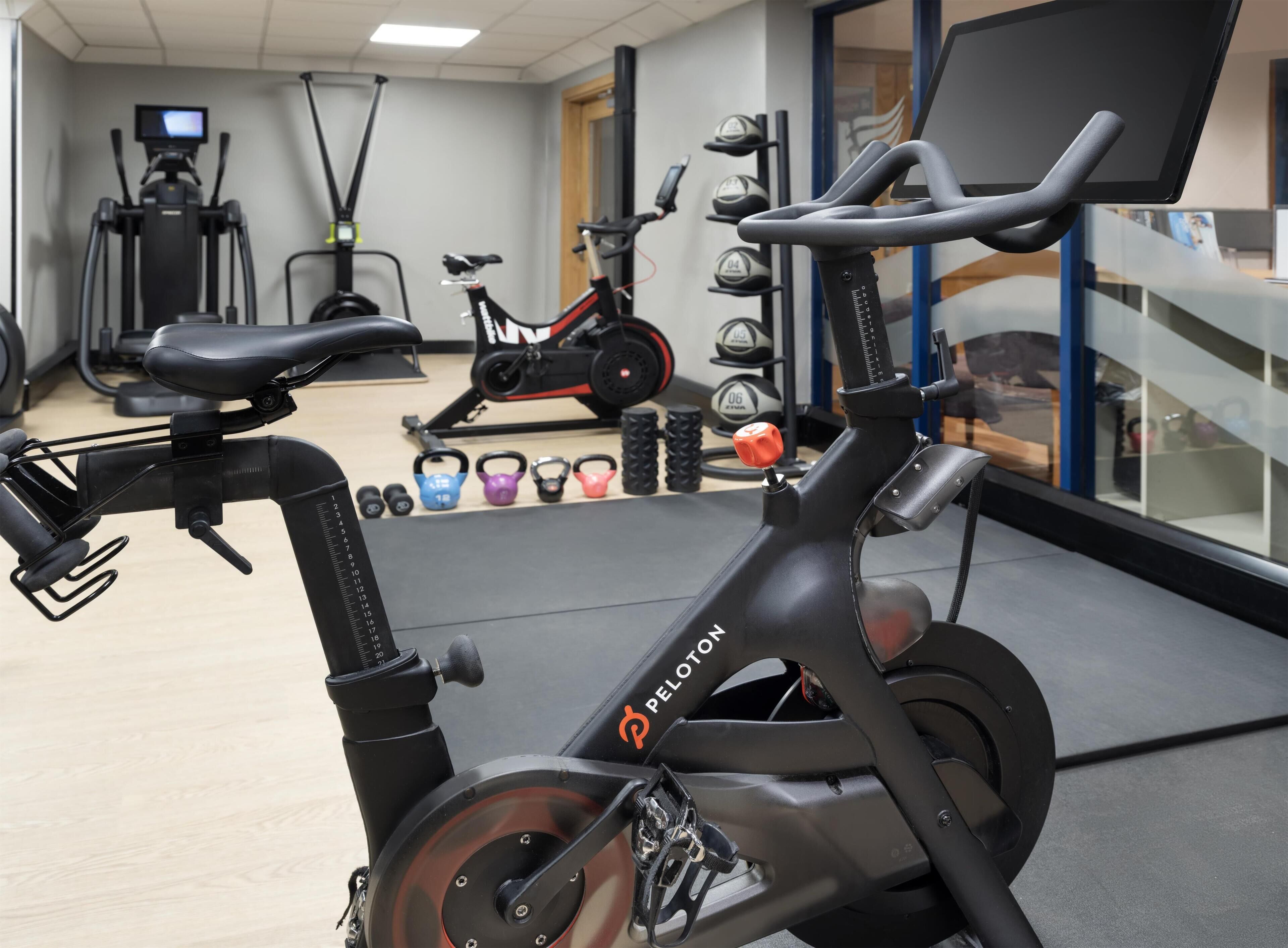 An indoor gym with stationary bikes, treadmills, and free weights.