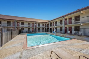 Seasonal outdoor pool, open 10:00 AM to 10 PM, pool umbrellas - Red Roof Inn College Station (College Station)