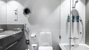 A modern bathroom with a toilet, bidet, and shower.