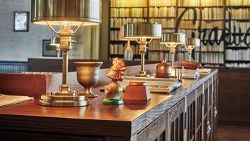 A library with bookshelves and reading lamps.