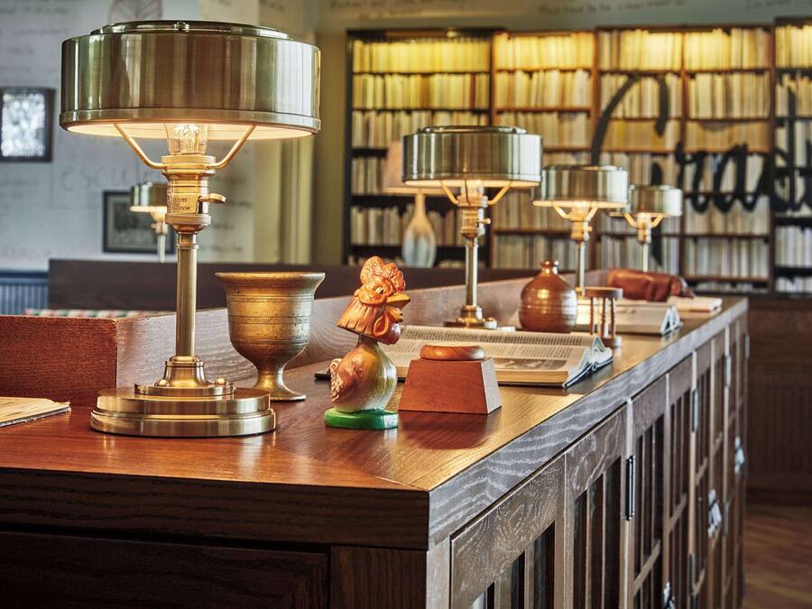 A library with bookshelves and reading lamps.