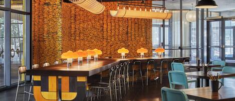 A modern bar area with a unique wooden wall, multiple bar stools, and ambient lighting.