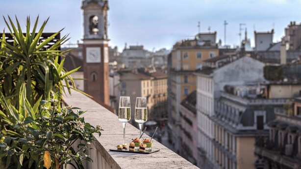 A balcony with a view of a cityscape, featuring a clock tower and buildings. - Starhotels Ritz (Milan)