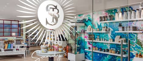 A modern interior with a central display and shelves filled with various items.