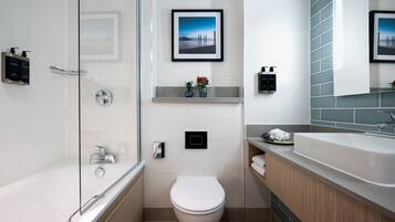 A modern bathroom with a bathtub, toilet, and sink.