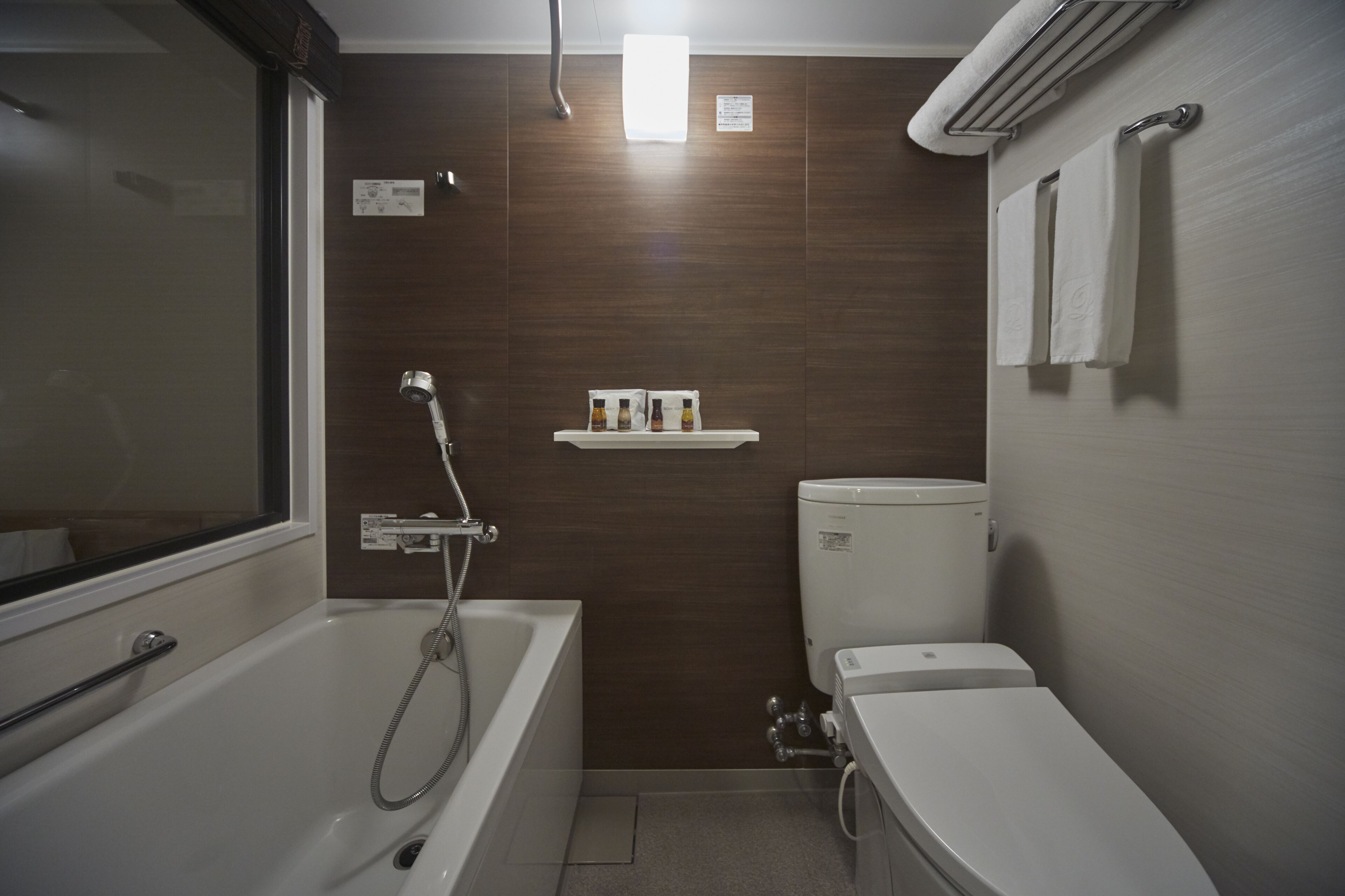 A bathroom with a bathtub, toilet, and a shower.
