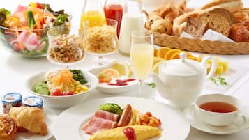 A breakfast table with various dishes including eggs, toast, and a salad.