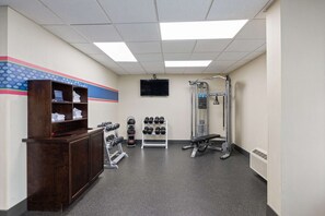 Stay fit and active with our fully equipped fitness center featuring a reception desk, TV, and a range of exercise equipment.