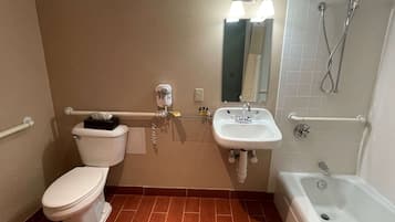 A bathroom with a toilet, sink, and bathtub.