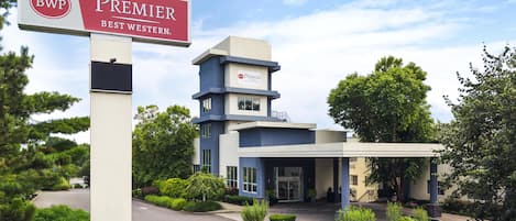 A hotel with a prominent sign reading 'BWP Premier Best Western.'