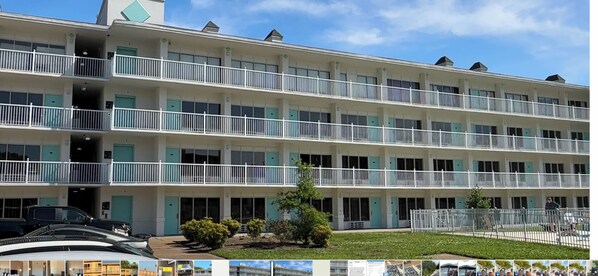 A multi-story hotel with balconies, a parking area, and a small garden.