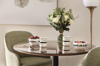 Hotel amenities such as safe, desk and work area at The Gardens Sonesta ES Suites New York