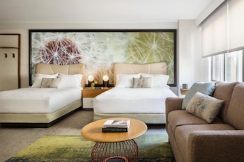 Hotel amenities such as safe, desk and work area at The Gardens Sonesta ES Suites New York