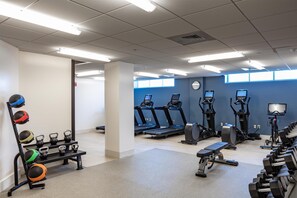 A gym with treadmills, elliptical machines, a bench, and a rack of kettlebells. - The Yorktowne Hotel, Tapestry Collection by Hilton (York)