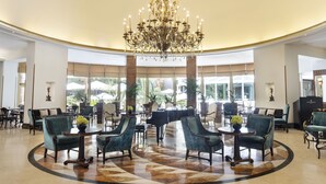 A spacious lobby with a grand chandelier, comfortable seating, and large windows offering a view of the outdoors. - InterContinental Madrid by IHG (Madrid)
