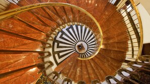 Stunning spiral staircase with a striking sunburst pattern and polished handrail.