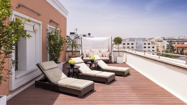 A rooftop terrace with lounge chairs, a sofa, and potted plants. - InterContinental Madrid by IHG (Madrid)