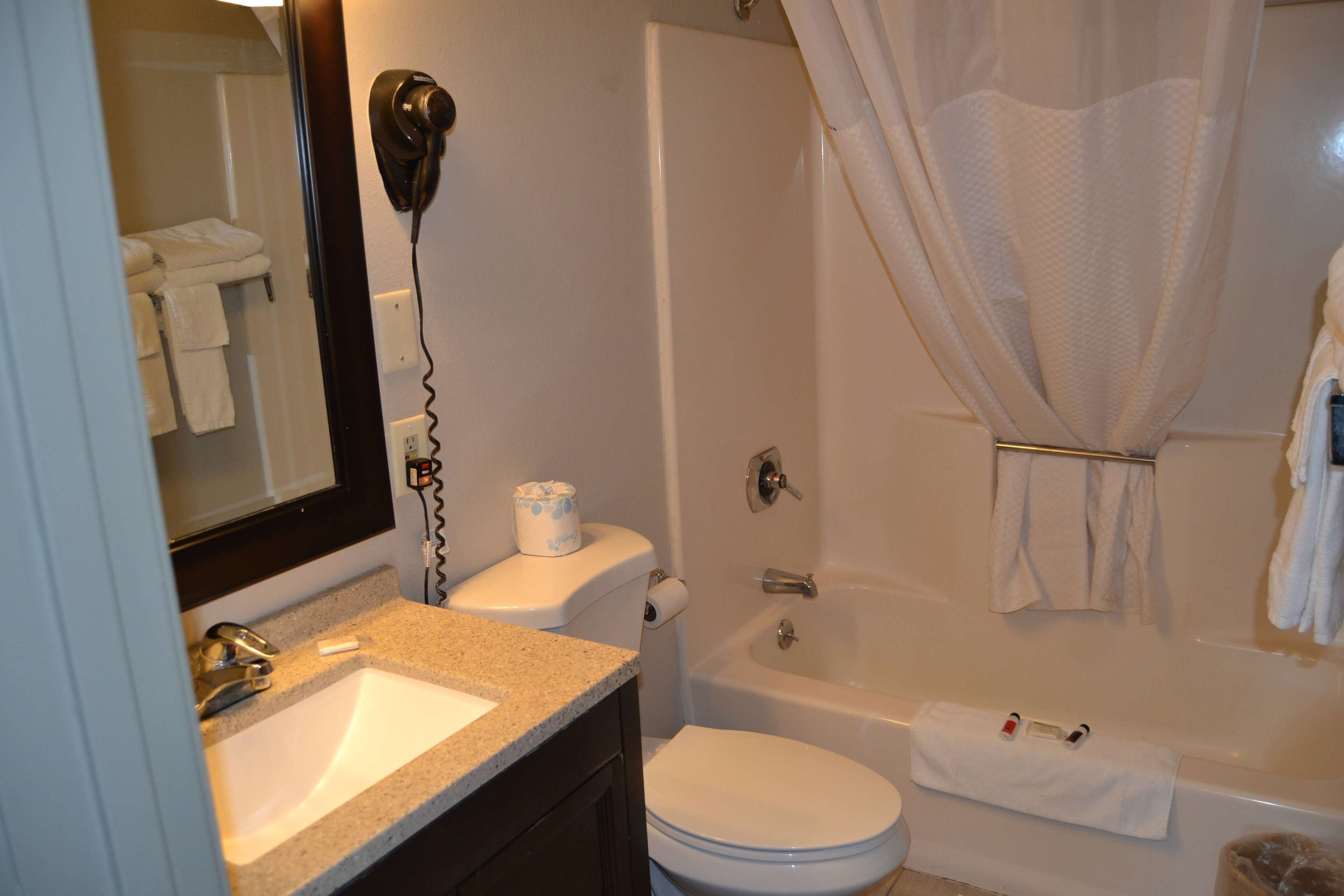 A bathroom with a sink, toilet, and bathtub.