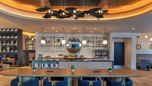A modern kitchen with a central island, bar area, and seating. - Sheraton Boston, a Marriott Hotel (Boston)