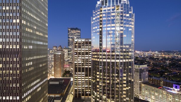 A high-rise building with a distinctive dome structure and reflective glass facade, surrounded by other tall buildings in a cityscape. - Sheraton Boston, a Marriott Hotel (Boston)