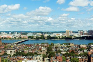 A cityscape with a river, historic buildings, and a bridge.