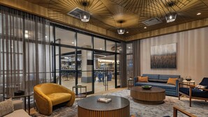 A modern interior with a sofa, armchairs, and a coffee table. - Sheraton Boston, a Marriott Hotel (Boston)