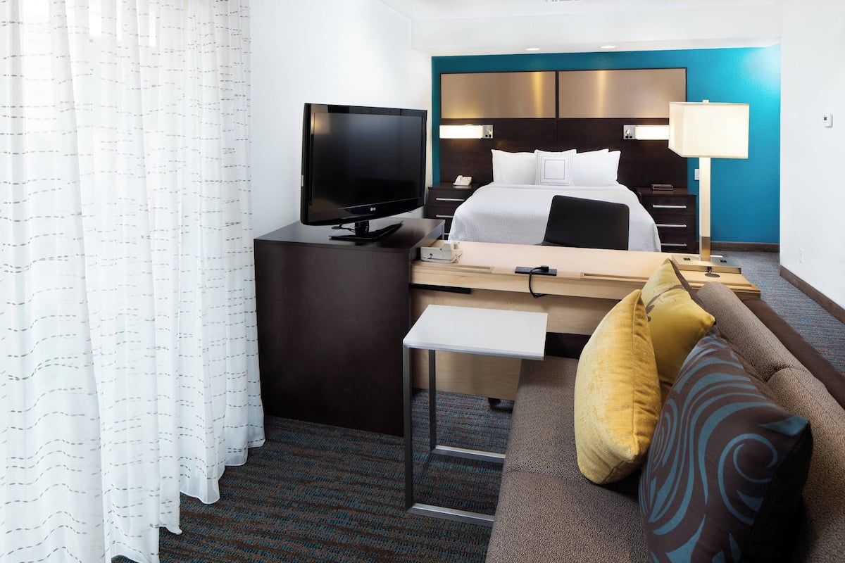 Premium bedding, desk, laptop workspace, blackout drapes