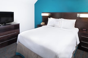 Premium bedding, desk, laptop workspace, blackout drapes