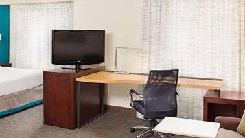 Premium bedding, desk, laptop workspace, blackout drapes