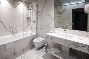 Enjoy a relaxing soak in the bathtub and get ready in the spacious vanity area.