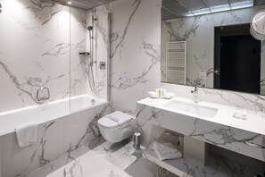 Enjoy a relaxing soak in the bathtub and get ready in the spacious vanity area.