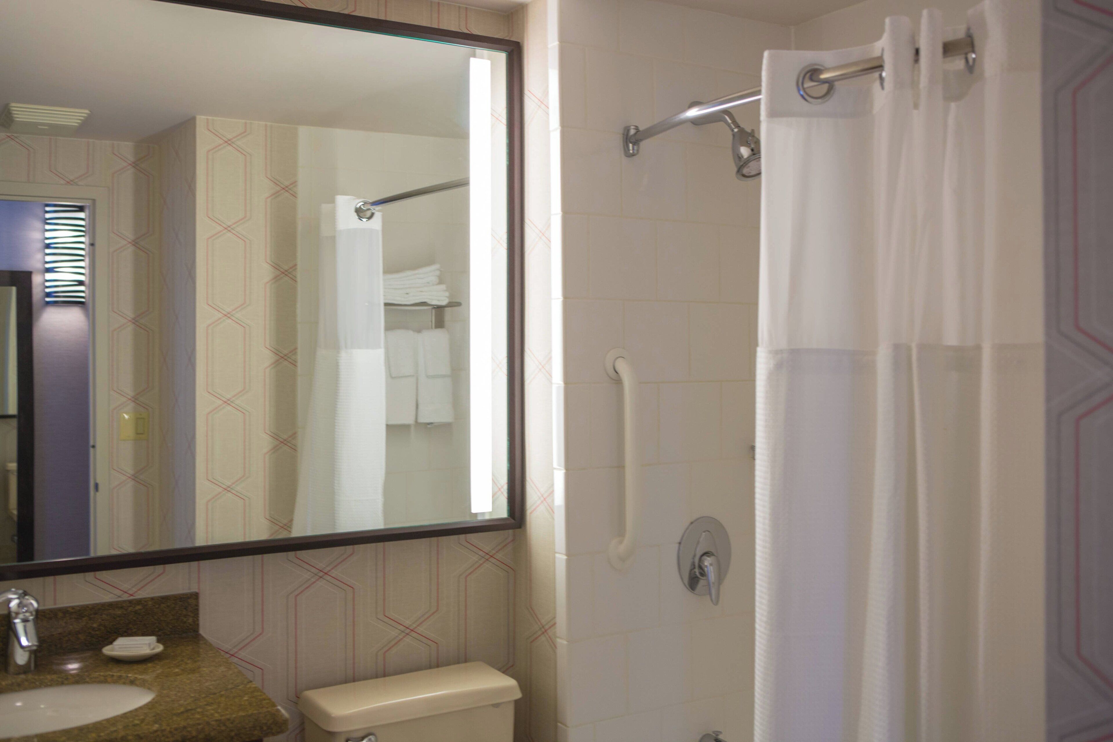 combined shower/bathtub, designer toiletries, hair dryer, towels