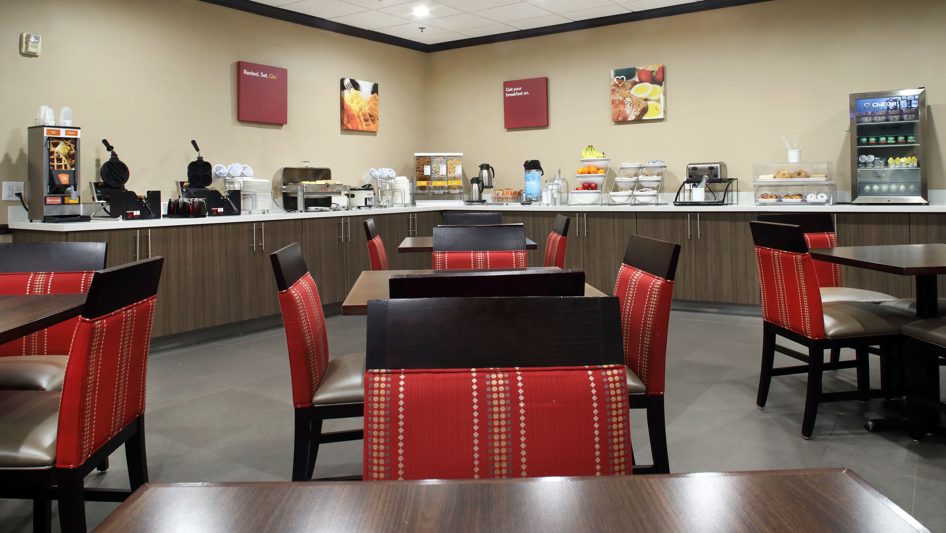 A breakfast area with a counter, seating, and a vending machine.