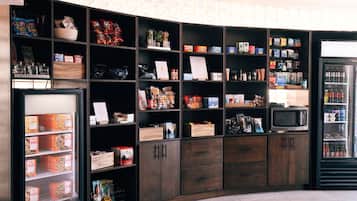 A well-organized kitchen area with various food items, a microwave, and a refrigerator.