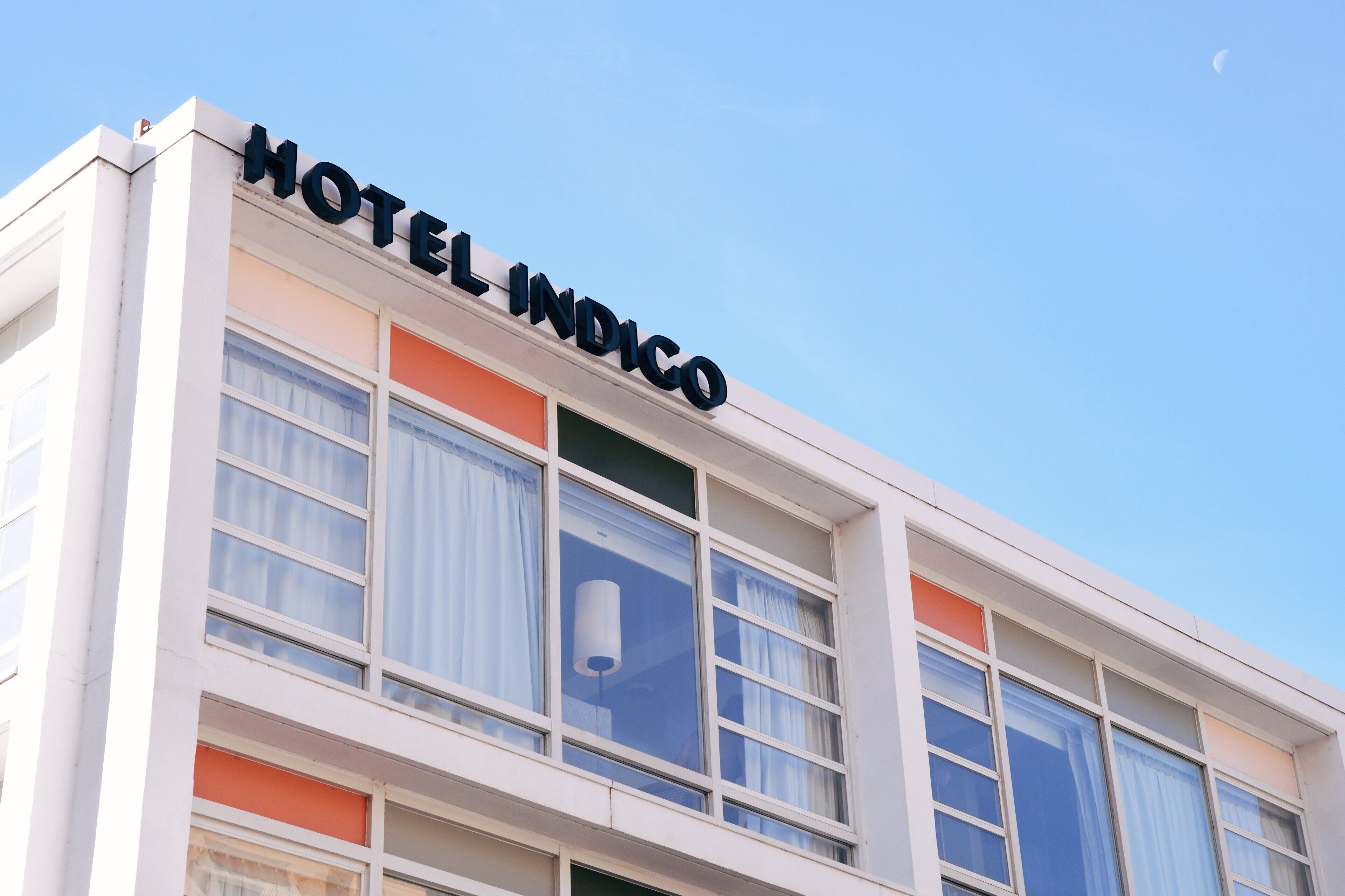 A building with the sign "HOTEL INDICO" on the facade.