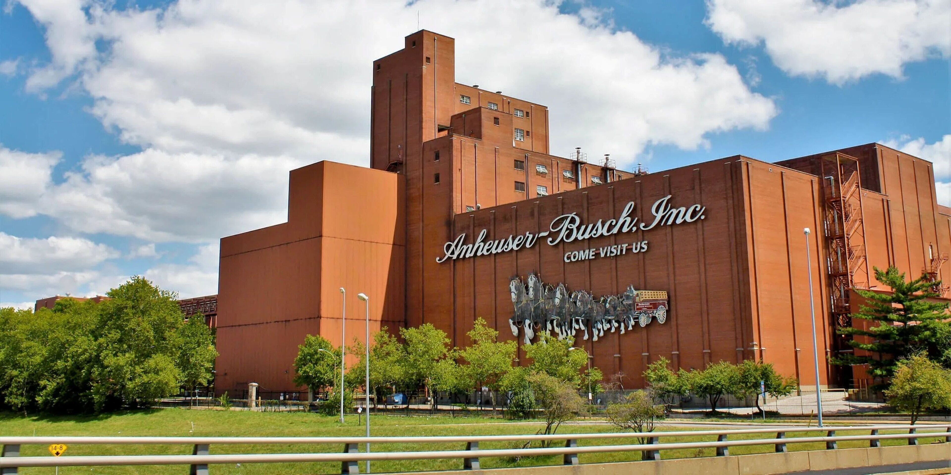 A large building with a prominent sign reading "Avery Busch, Inc." and a mural of horses and a wagon.