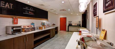 A kitchen area with a toaster, bread, and a coffee machine.