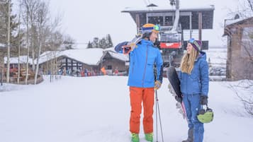 A snowy outdoor scene with a ski lift in the background.
