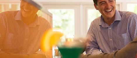 A bar area with a person holding a cocktail.