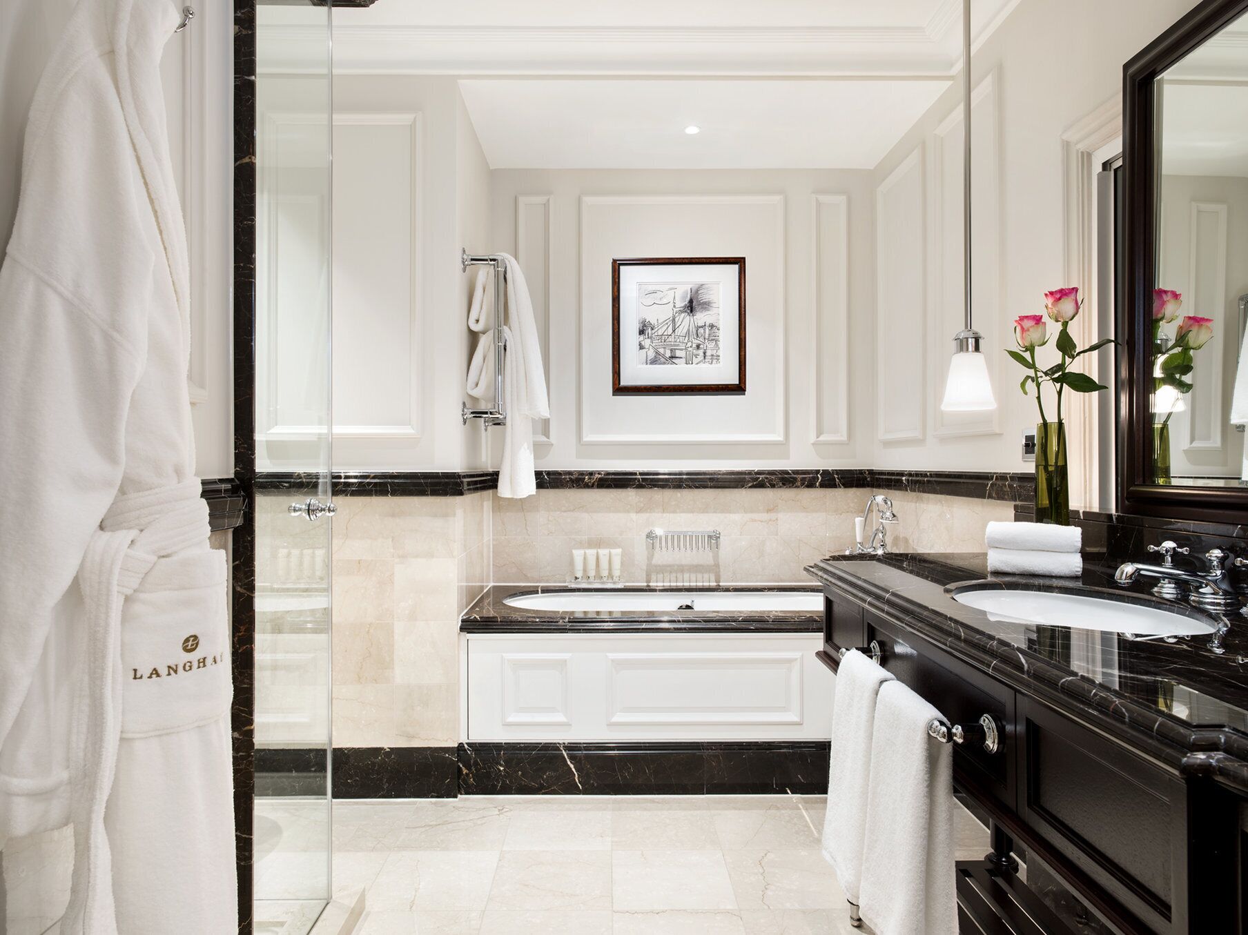 A modern bathroom with a large mirror, a bathtub, and a vanity with a sink.